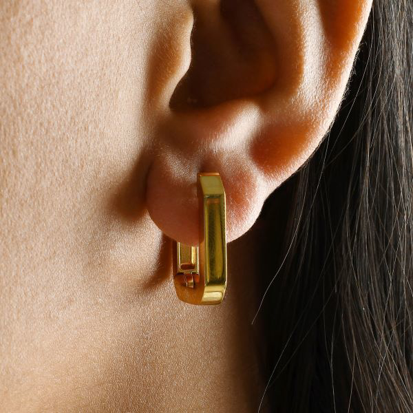 Show details for Octagon Hoop Earrings A pair of gold-plated modern octagon hoop earrings, highlighting the distinct faceted edges and eight-sided geometric shape.